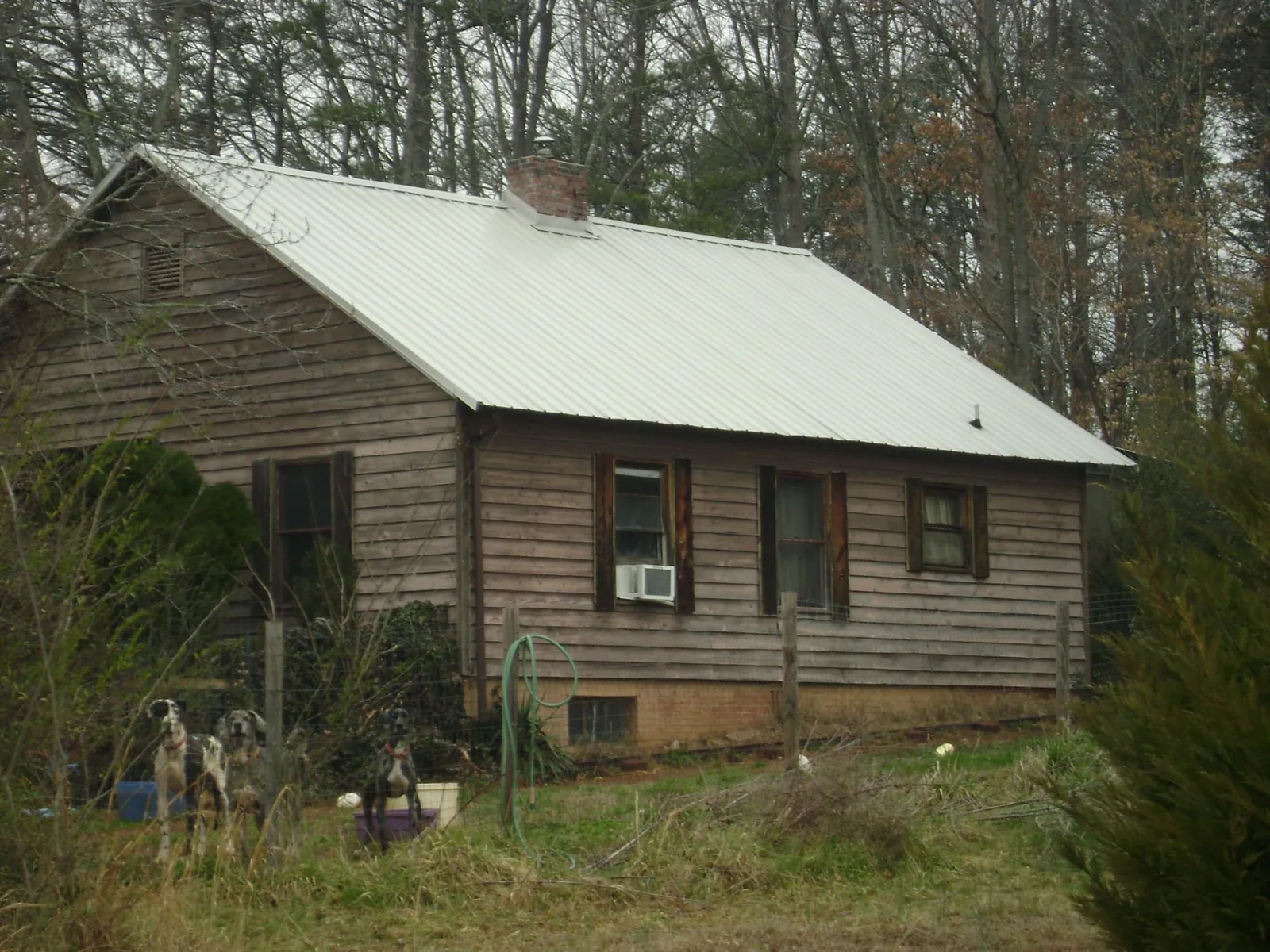 White metal roof on an old wood sided farmhouse, from a Metal Roof Installation job in Conesville